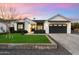 Charming two-story home with white siding, black accents, a manicured lawn, and a paved driveway at 3538 E Glenrosa Ave, Phoenix, AZ 85018