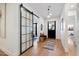 Inviting hallway featuring a sliding barn door, bench, and contemporary design at 3538 E Glenrosa Ave, Phoenix, AZ 85018