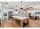 Open concept kitchen with a central island, stainless steel fridge, wood floors, and seamless flow to the dining area at 3538 E Glenrosa Ave, Phoenix, AZ 85018