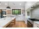 Bright kitchen featuring white cabinetry, marble counters, stainless appliances, and center island with chairs at 3538 E Glenrosa Ave, Phoenix, AZ 85018