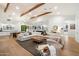 Spacious living room featuring hardwood floors, exposed beams, and an open floor plan at 3538 E Glenrosa Ave, Phoenix, AZ 85018