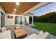 Inviting outdoor patio with wood ceiling, comfortable seating, and views of the lush backyard at 3538 E Glenrosa Ave, Phoenix, AZ 85018