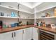 Well-organized pantry with a butcher block countertop, white shelving, and beverage cooler at 3538 E Glenrosa Ave, Phoenix, AZ 85018