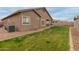 View of the backyard featuring a green lawn and the exterior of the home at 3768 S Coach House Dr, Gilbert, AZ 85297