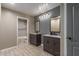 Bathroom featuring dual vanities, gray accent wall, and wood tile flooring at 3768 S Coach House Dr, Gilbert, AZ 85297