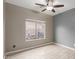 Bedroom with a ceiling fan, wood floors, and a window with outside view at 3768 S Coach House Dr, Gilbert, AZ 85297