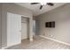 Bedroom showcasing closet doors and a mounted tv, ceiling fan and wood floors at 3768 S Coach House Dr, Gilbert, AZ 85297