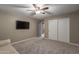 Bedroom with a ceiling fan, closet, mounted tv, and gray walls at 3768 S Coach House Dr, Gilbert, AZ 85297