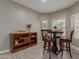 A cozy dining area featuring a dark wood table with bar stools, a shelf, and windows for lots of natural light at 3768 S Coach House Dr, Gilbert, AZ 85297