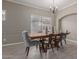 Traditional dining room features decorative lighting, a large window, and wood-look tile flooring at 3768 S Coach House Dr, Gilbert, AZ 85297