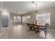 Spacious dining room with tile flooring and a decorative chandelier, great for entertaining at 3768 S Coach House Dr, Gilbert, AZ 85297