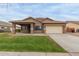 Inviting single-story home featuring a manicured lawn and a spacious two-car garage at 3768 S Coach House Dr, Gilbert, AZ 85297