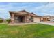 Charming single-story home offering a covered entryway and beautifully maintained green lawn at 3768 S Coach House Dr, Gilbert, AZ 85297