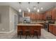 Modern kitchen with a center island, stainless steel appliances, pendant lights, and sleek cabinets at 3768 S Coach House Dr, Gilbert, AZ 85297