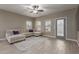 Cozy living room features tile floors, a ceiling fan, a plush sectional, and natural light at 3768 S Coach House Dr, Gilbert, AZ 85297