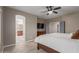 A main bedroom featuring neutral colors, wood floors, a flat-screen TV, and an open door to the main bathroom at 3768 S Coach House Dr, Gilbert, AZ 85297