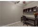 Office space featuring a dark wood desk, a custom shelf, and wood tile flooring at 3768 S Coach House Dr, Gilbert, AZ 85297