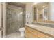 Well-lit bathroom with glass shower, vanity with granite countertop and framed mirror at 3800 S Cantabria Cir # 1013, Chandler, AZ 85248