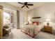 Bedroom featuring a ceiling fan, carpet floors, and a sliding glass door to the balcony at 3800 S Cantabria Cir # 1013, Chandler, AZ 85248