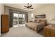 Bedroom with sliding glass doors to outdoor seating area, ceiling fan, and neutral décor at 3800 S Cantabria Cir # 1013, Chandler, AZ 85248