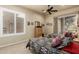 Bright bedroom featuring carpet floors, ceiling fan, shuttered windows and Southwestern decor at 3800 S Cantabria Cir # 1013, Chandler, AZ 85248