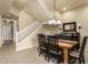 A formal dining room with a wooden table, black chairs, and modern lighting at 3800 S Cantabria Cir # 1013, Chandler, AZ 85248