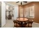 Cozy dining area with a round table and leather chairs, adjacent to the living room with a fireplace at 3800 S Cantabria Cir # 1013, Chandler, AZ 85248