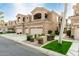 A two-story home featuring a multi-car garage, a second story balcony and desert landscaping at 3800 S Cantabria Cir # 1013, Chandler, AZ 85248