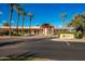 Exterior shot of Ocotillo Golf Club with beautiful landscaping, palm trees and covered walkway at 3800 S Cantabria Cir # 1013, Chandler, AZ 85248