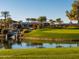 Beautiful view of the golf course and country club overlooking lush green grass and serene pond with waterfall feature at 3800 S Cantabria Cir # 1013, Chandler, AZ 85248