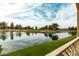 Scenic view of a lush golf course island surrounded by a serene lake, reflecting the cloudy blue sky at 3800 S Cantabria Cir # 1013, Chandler, AZ 85248