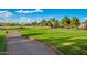 Well-maintained golf course with green fairways, a golf cart, and residences in the background at 3800 S Cantabria Cir # 1013, Chandler, AZ 85248