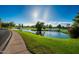 Scenic view of lush green golf course next to lake, complete with bridge and landscaping at 3800 S Cantabria Cir # 1013, Chandler, AZ 85248