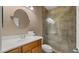 Bathroom featuring tiled shower, vanity with sink and modern fixtures at 3872 E Flower St, Gilbert, AZ 85298