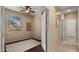 Neutral bedroom featuring laminate floors, ceiling fan, and large window at 3872 E Flower St, Gilbert, AZ 85298