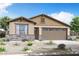 Charming single-story home with a two-car garage, stone accents, and desert landscaping at 3915 S 241St Ln, Buckeye, AZ 85326