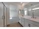 Bright bathroom featuring a double sink vanity, sleek fixtures, and a separate glass-enclosed shower at 4069 W Nora Dr, San Tan Valley, AZ 85144