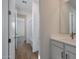 Hallway view of a well-lit bathroom featuring a modern vanity and a tub-shower combination at 4069 W Nora Dr, San Tan Valley, AZ 85144