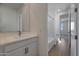 Bathroom featuring a single sink vanity with a white countertop and a tub with a shower in the background at 4069 W Nora Dr, San Tan Valley, AZ 85144