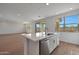 Kitchen features a large island with stainless steel appliances, seating, and natural light at 4069 W Nora Dr, San Tan Valley, AZ 85144