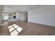 Bright living room featuring wood-look floors and an open layout that connects to the kitchen at 4069 W Nora Dr, San Tan Valley, AZ 85144