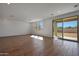 Spacious living room with wood-look floors and sliding glass doors leading to the outdoor at 4069 W Nora Dr, San Tan Valley, AZ 85144