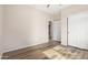 Neutral-toned bedroom featuring wood-look floors and a closet with sliding doors at 42906 W Darter Dr, Maricopa, AZ 85138