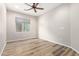 Bedroom featuring wood-look flooring and a window at 42906 W Darter Dr, Maricopa, AZ 85138