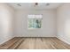 Bedroom featuring wood floors and a large window with natural light at 42906 W Darter Dr, Maricopa, AZ 85138