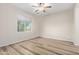 Bedroom with wood floors, ceiling fan and natural light at 42906 W Darter Dr, Maricopa, AZ 85138