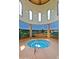 Indoor hot tub with views of a beautiful mural, providing a relaxing and luxurious experience at 42906 W Darter Dr, Maricopa, AZ 85138