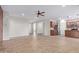 Bright living room with tile floors, ceiling fan and view to kitchen at 42906 W Darter Dr, Maricopa, AZ 85138