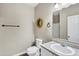 This bathroom features beige walls, a toilet, a vanity sink, and a decorative wreath at 4473 E Whitehall Dr, San Tan Valley, AZ 85140