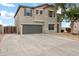 View of the home's side and front elevation featuring stucco exterior and driveway with a gate to the back yard at 4473 E Whitehall Dr, San Tan Valley, AZ 85140